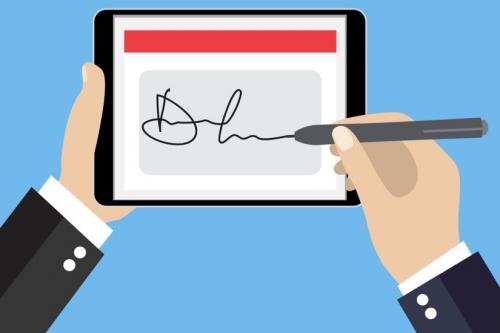 Hands signing an electronic signature on a tablet device 