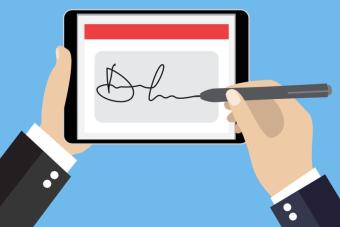 Hands signing an electronic signature on a tablet device 